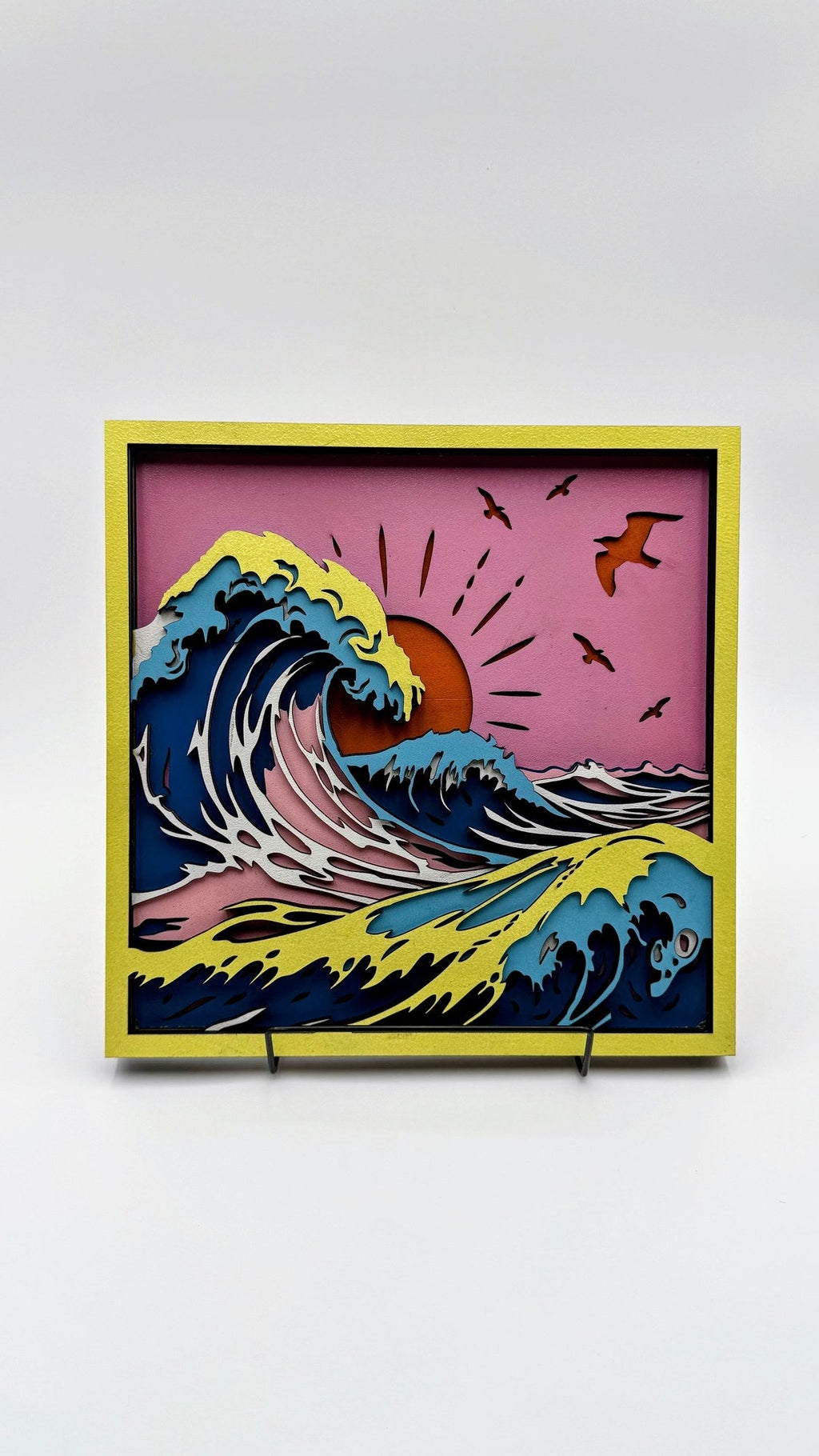 Layered wood sunset ocean wave wall art with yellow frame and coastal colors by Shoreline Custom Creations