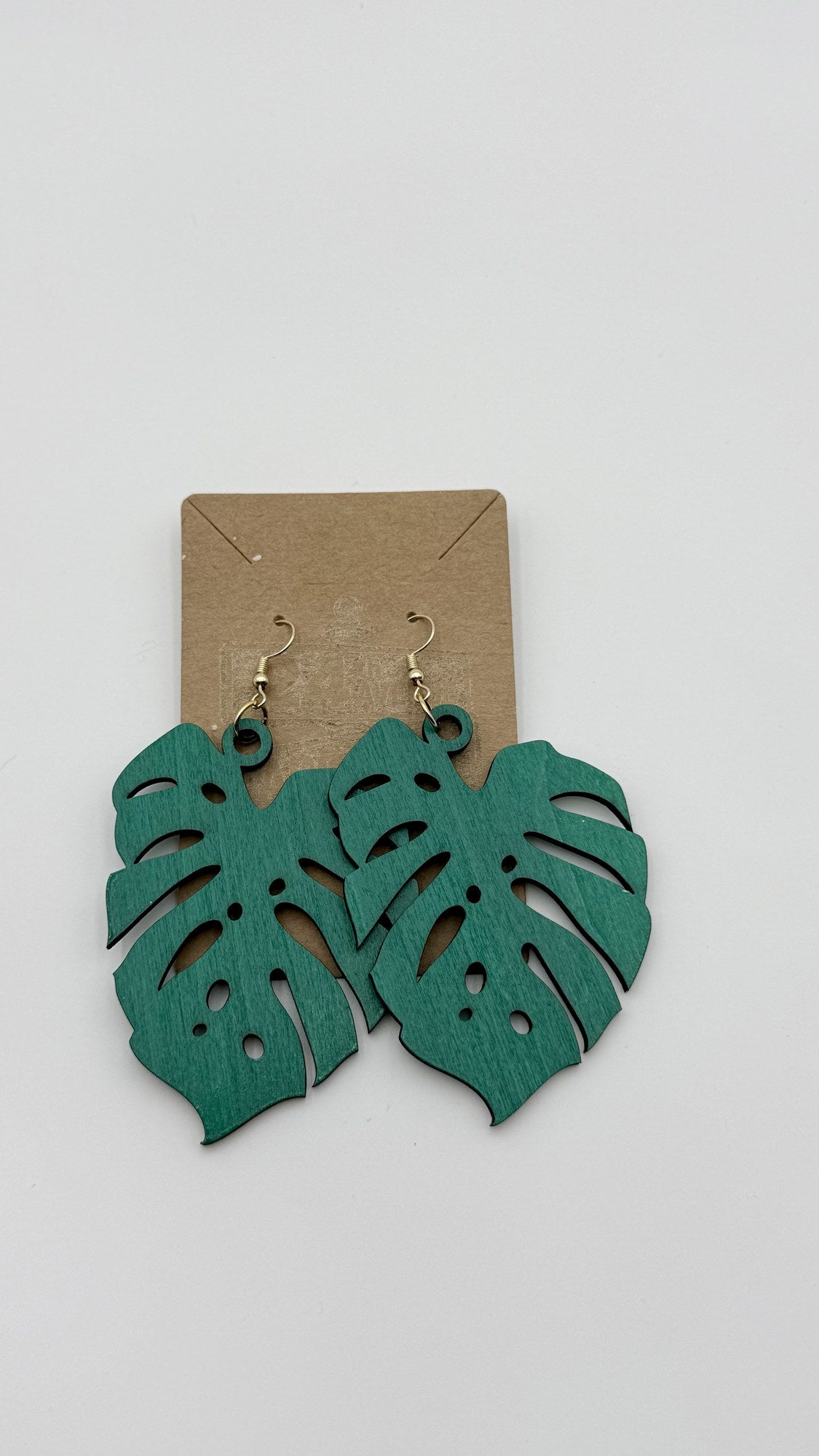 Hand-stained green monstera leaf wooden statement earrings, laser-cut tropical jewelry by Shoreline Custom Creations