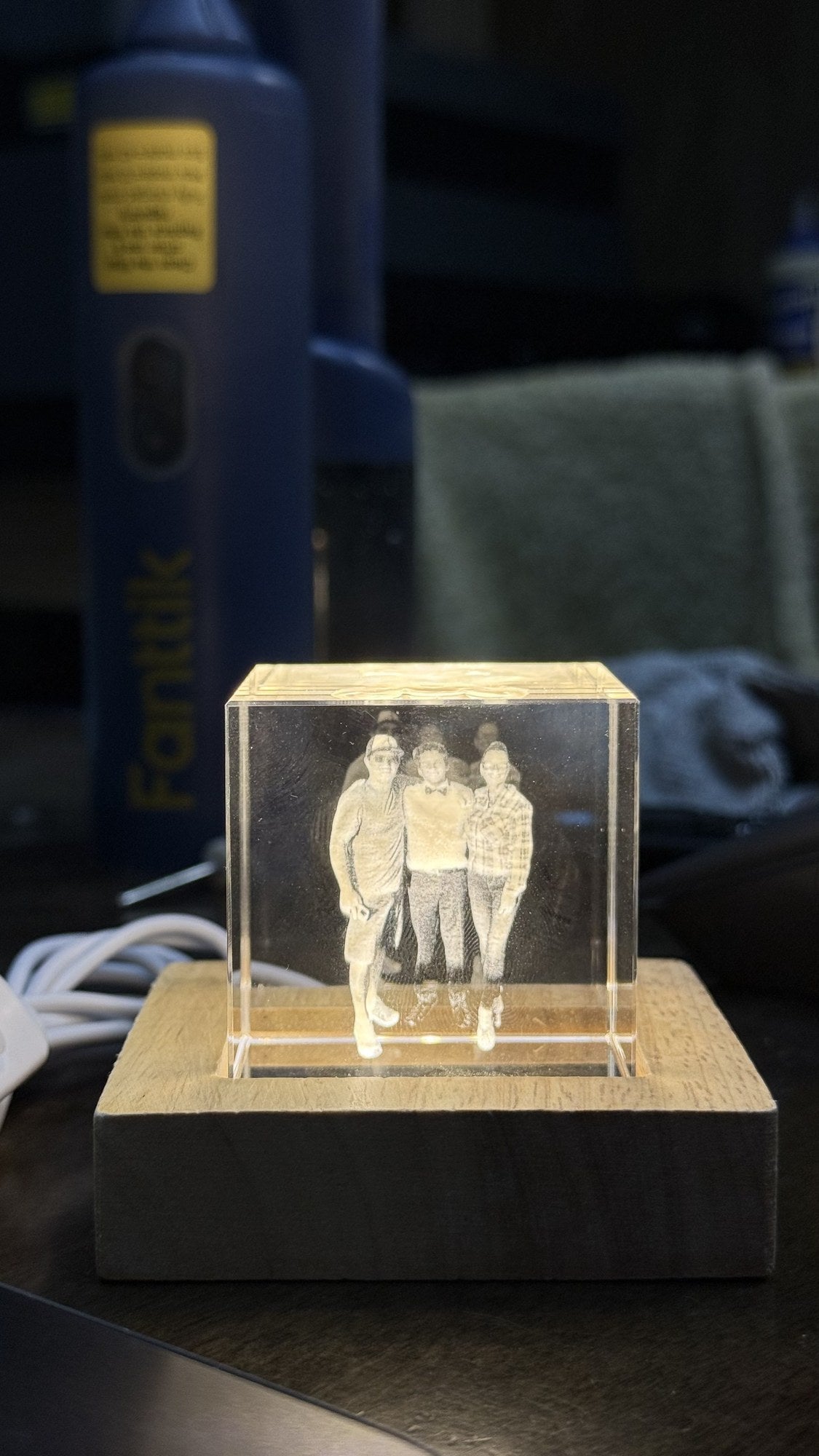 Custom 3D laser-engraved photo crystal of family portrait on lit wooden base by Shoreline Custom Creations